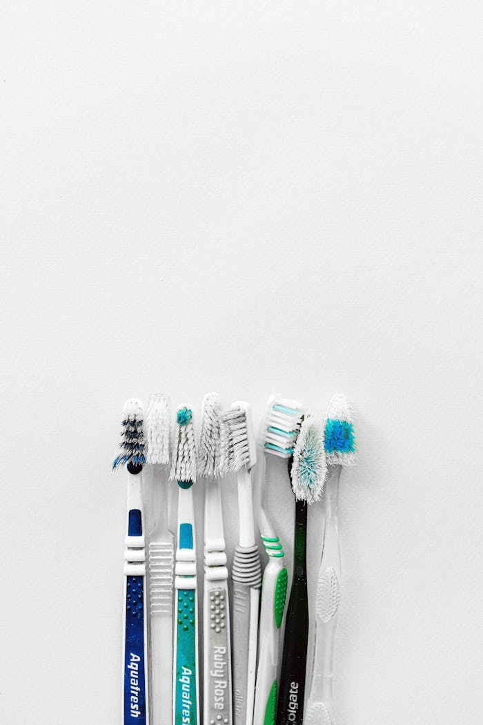 A collection of seven colorful toothbrushes on a white background, offering ample copy space.